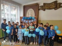 Uczniowie z niebieskimi balonami